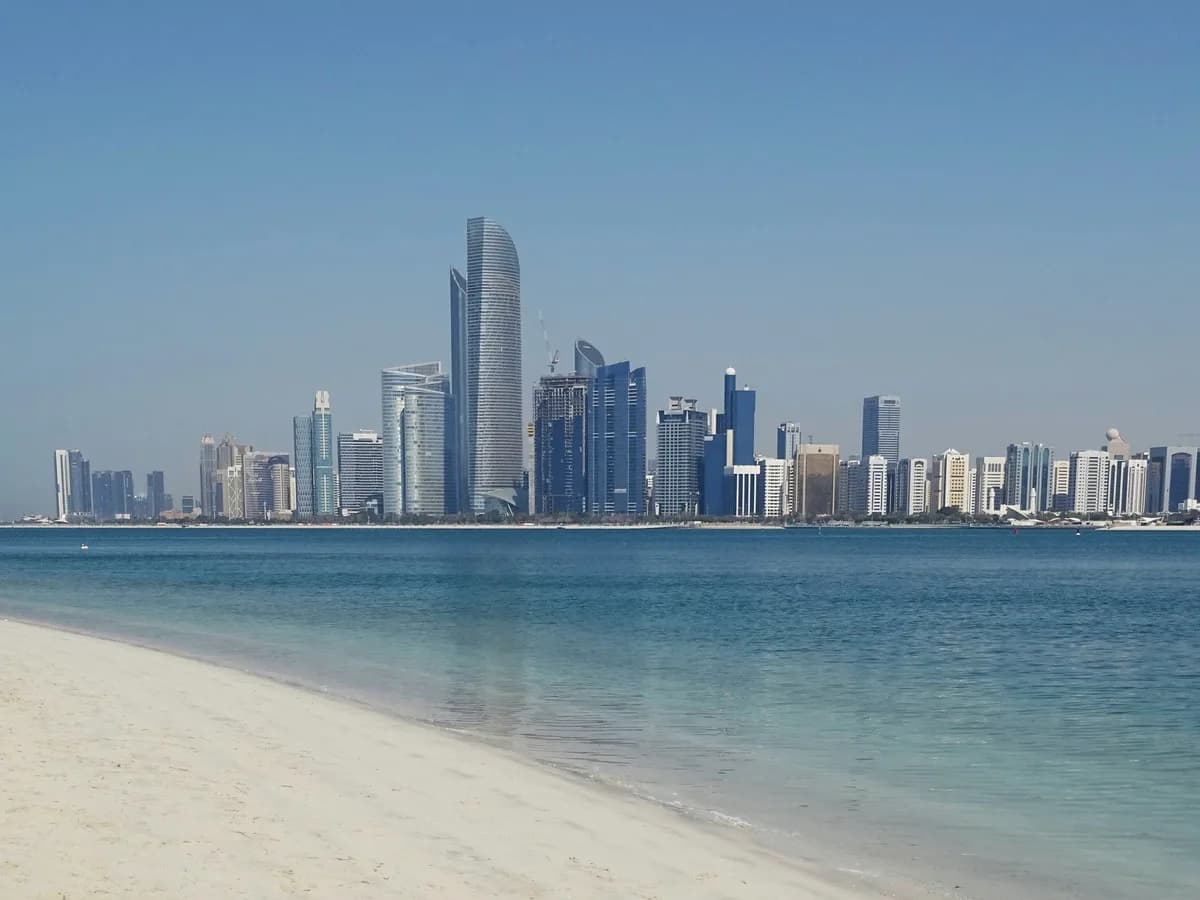 Abu Dhabi skyline seen across the water from the beach