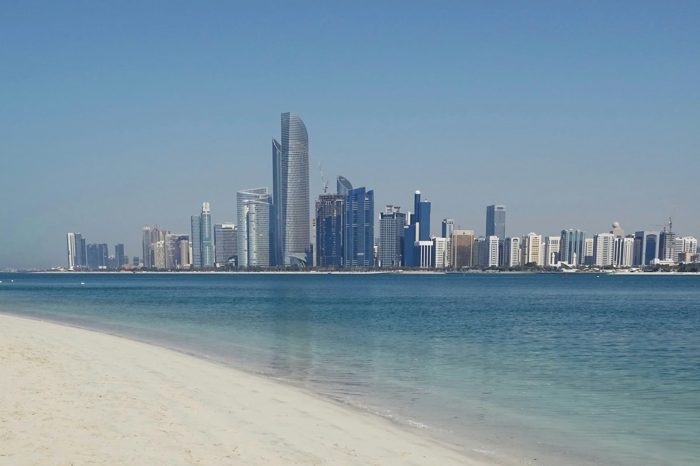 Abu Dhabi skyline seen across the water from the beach