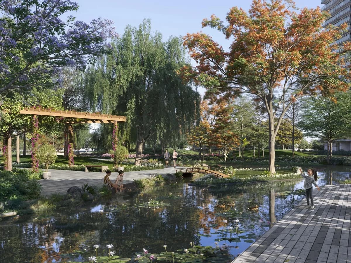 Artist's impression of a waterfront promenade with a pergola, small bridge, flowering trees and residents seated by the water