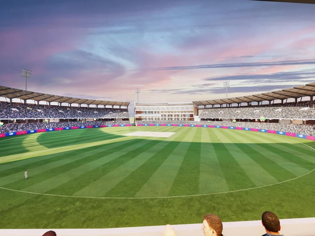 Render of the inside of the outdoor cricket stadium at dusk: striped outfield, full stands and floodlights