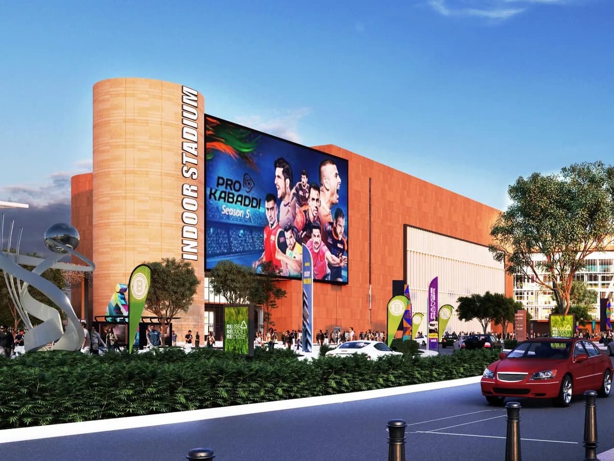 Render of the indoor stadium building with a large Pro Kabaddi screen, sculpture and landscaped drop-off road